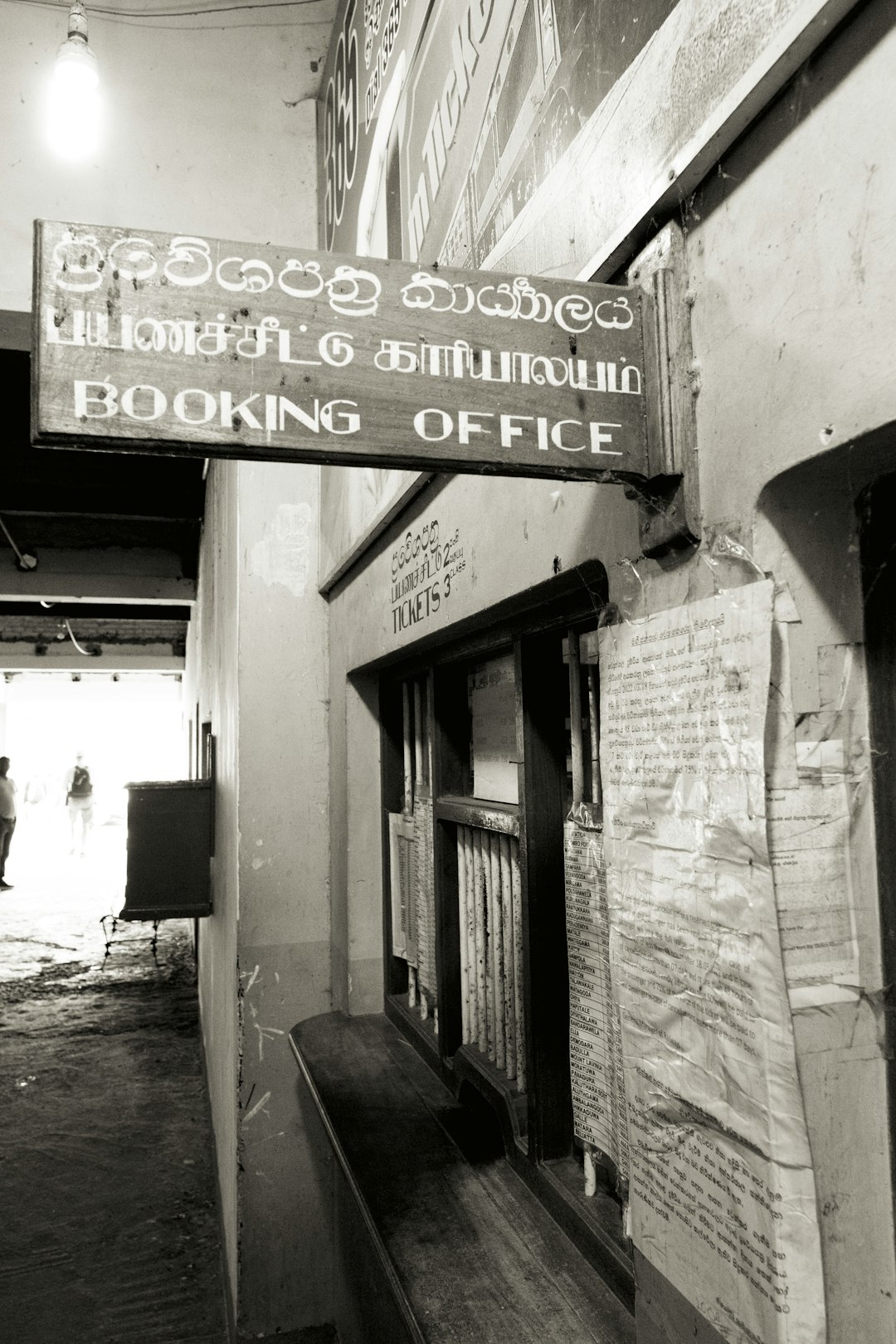 A weathered "booking office" sign hangs above a counter.
