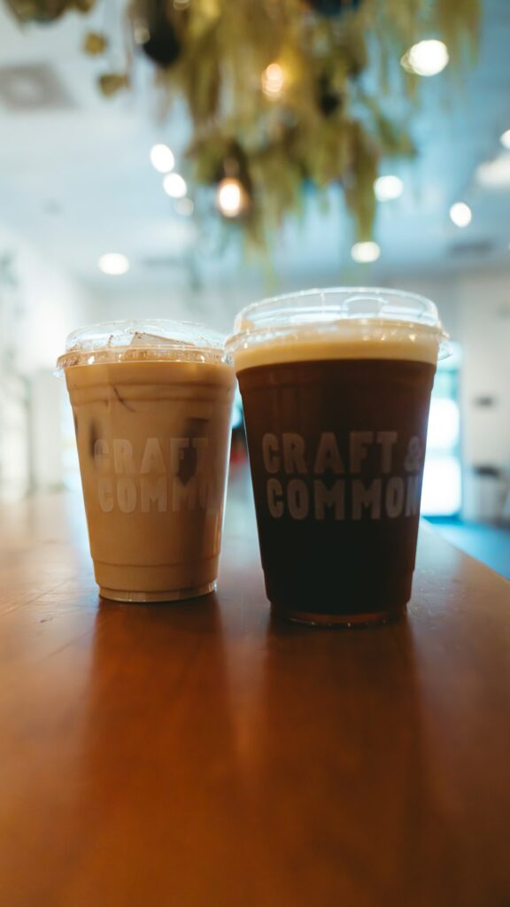 two cups of coffee sitting on top of a wooden table